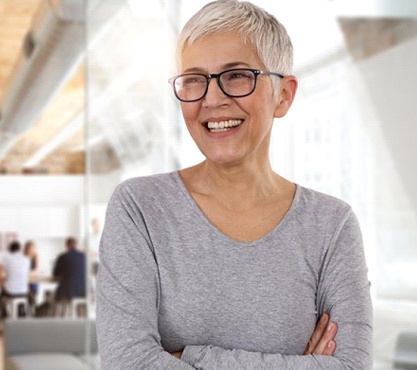 gray-haired woman smiling with dentures