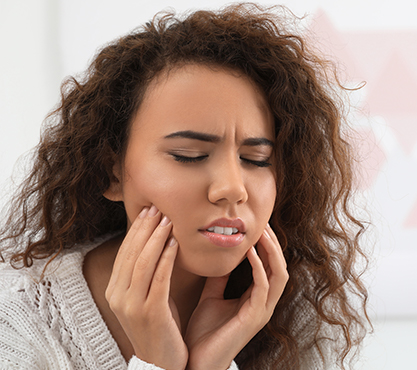 Woman holding the sides of her face