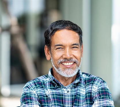 man in a plaid shirt smiling