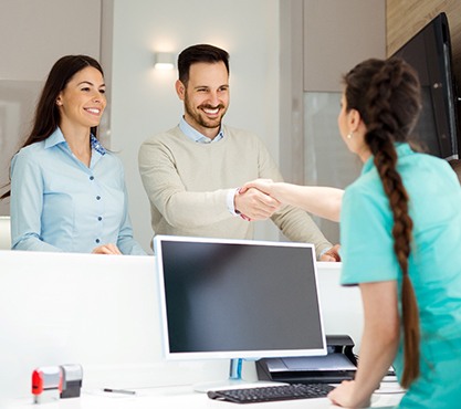 patient shaking hands with a dental team member