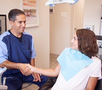 Dr. Mirsepasi shaking hands with dental patient