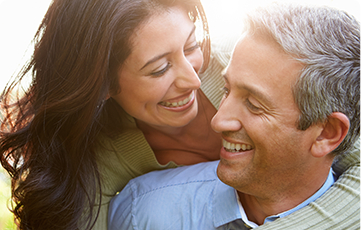 Smiling older man and woman outdoors