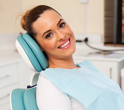 Woman in dental chair smiling