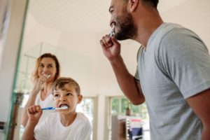 a family brushing their teeth at home 