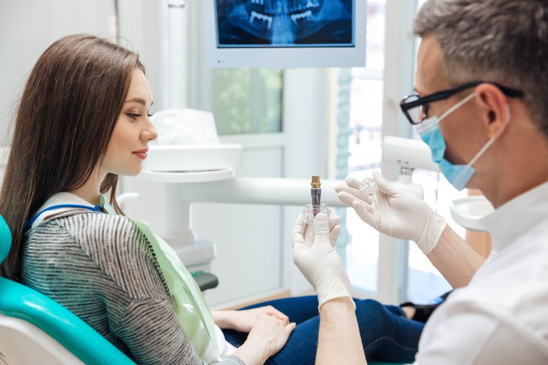 Dentist talking to patient about dental implants