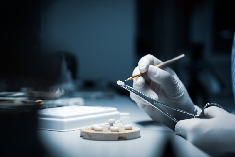 Worker processing dental crown